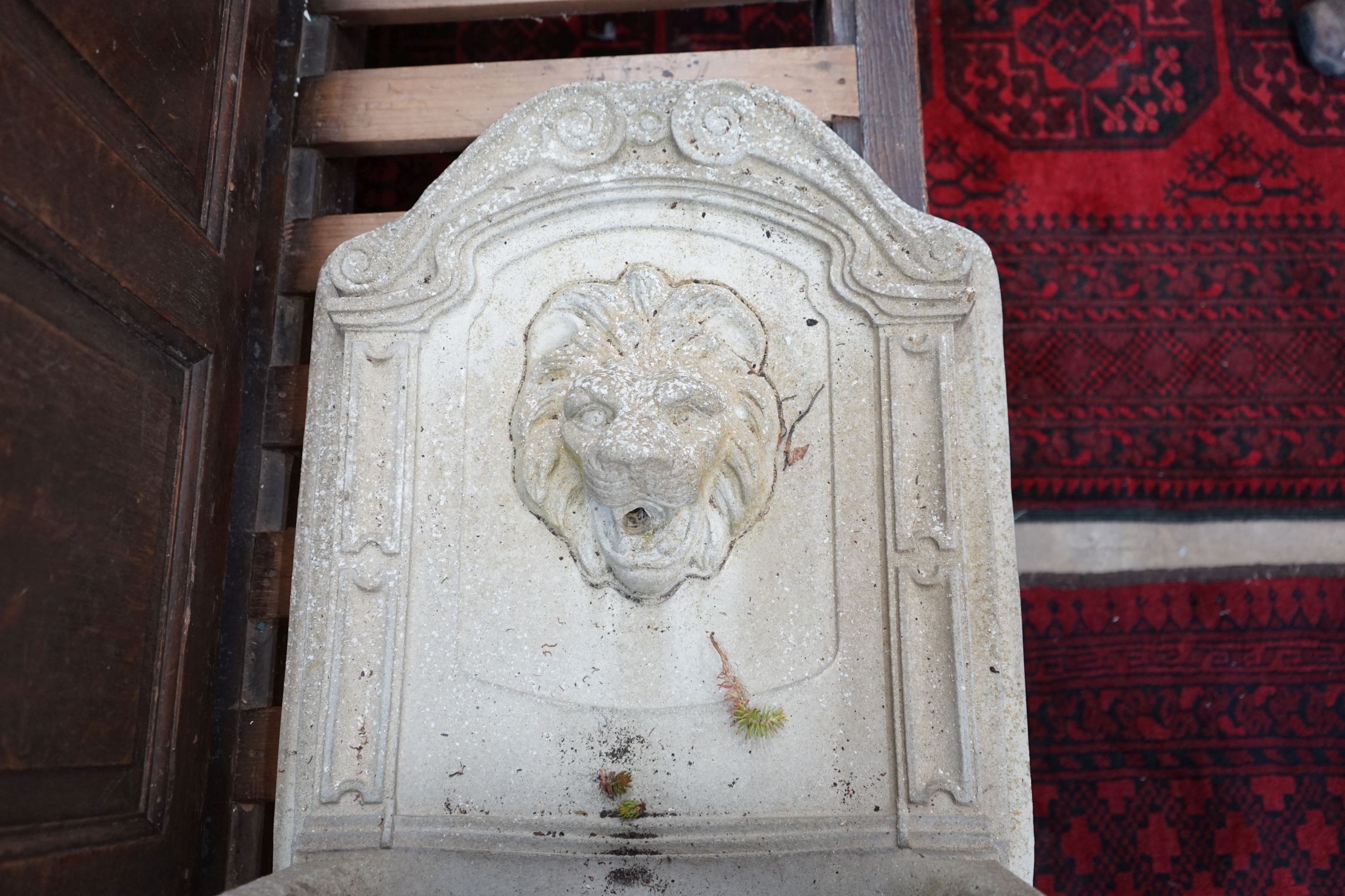 A reconstituted stone garden fountain with lion mask spout, height 75cm